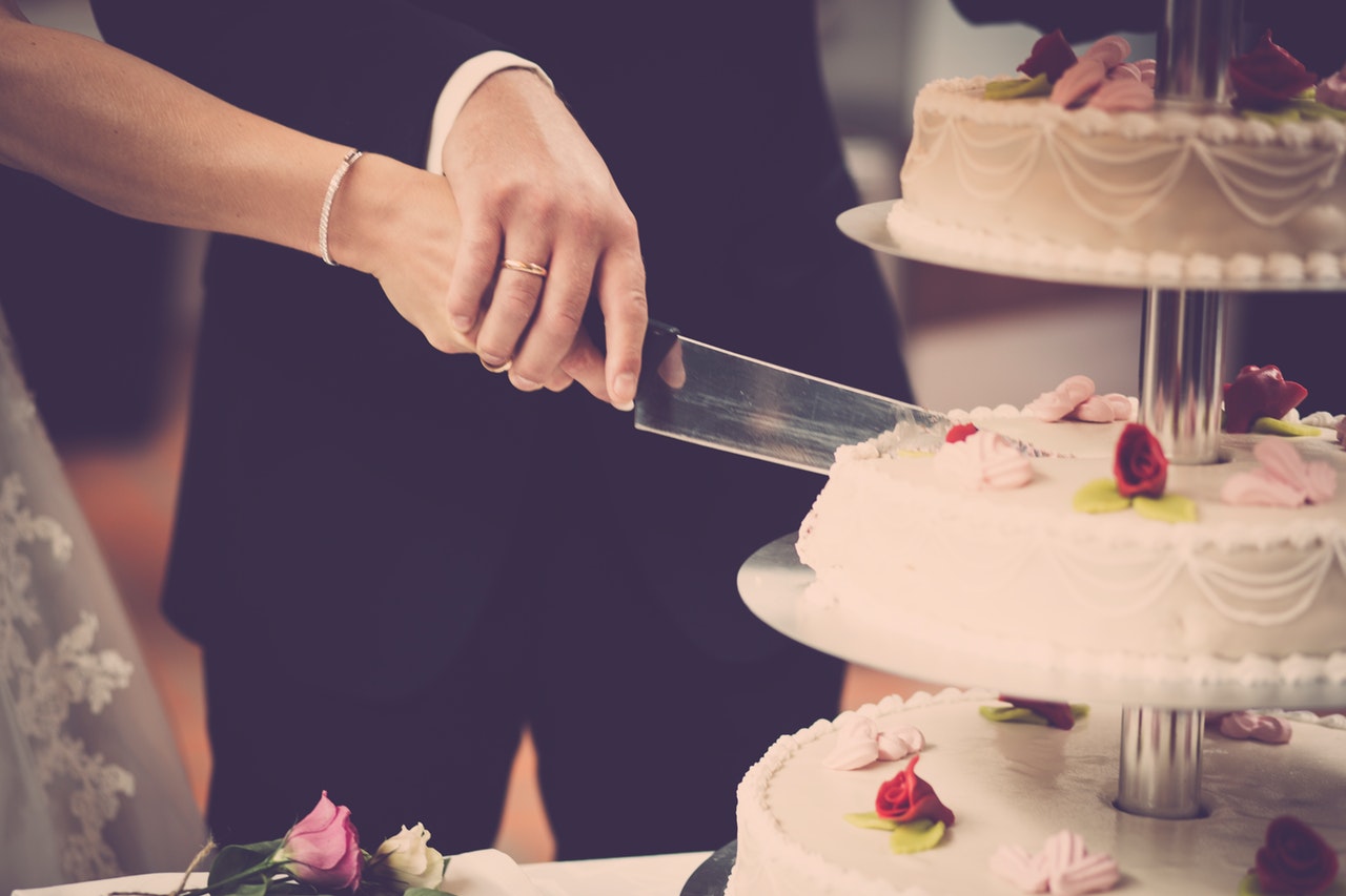 person-holding-knife-slicing-3-layer-cake-1345574.jpg